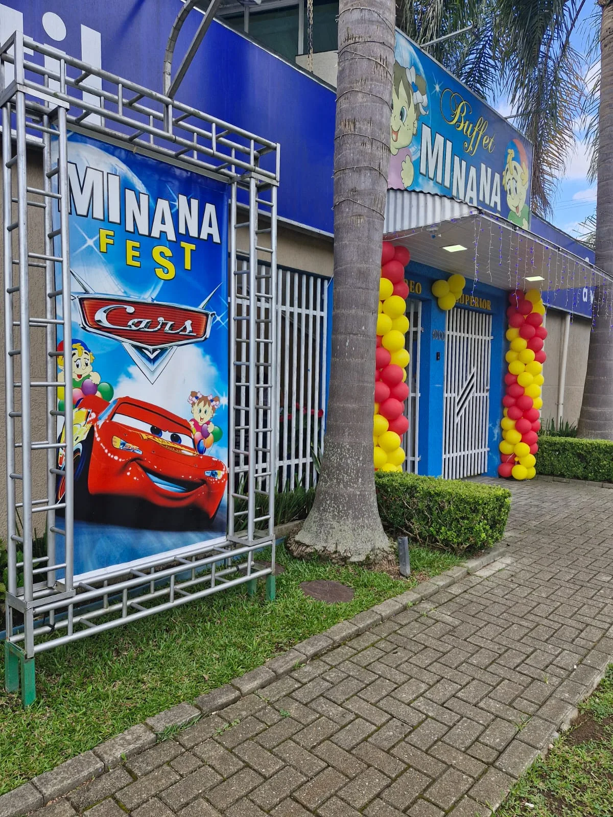 Entrada do MinanaFest decorada com o tema Naruto, com banner do anime, símbolo da folha e arco de balões nas cores laranja e preto